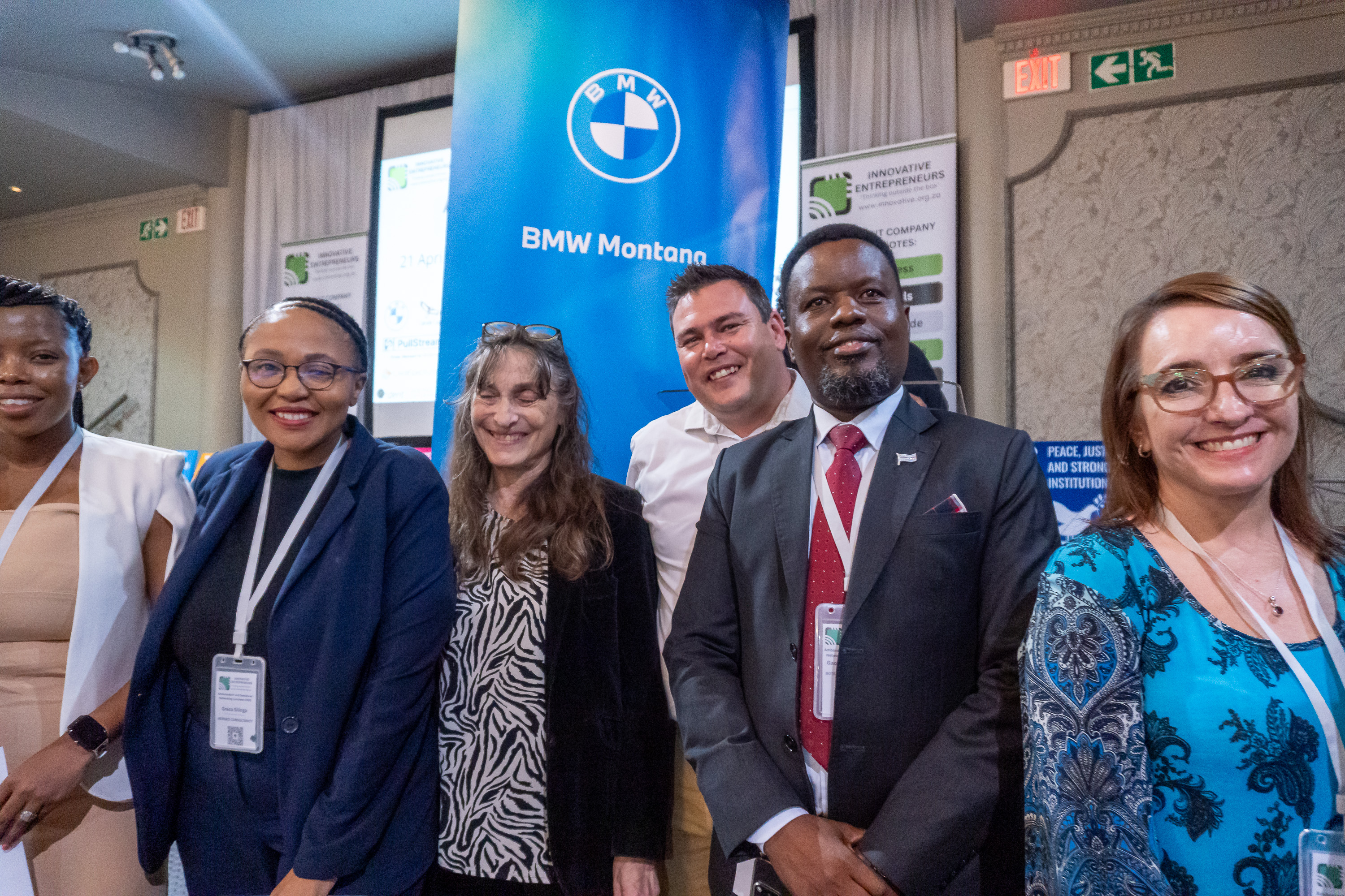 Delegates and partners at the Ambassadors' and Executives Networking Luncheon 2026 in front of the BMW Montana sponsor banner