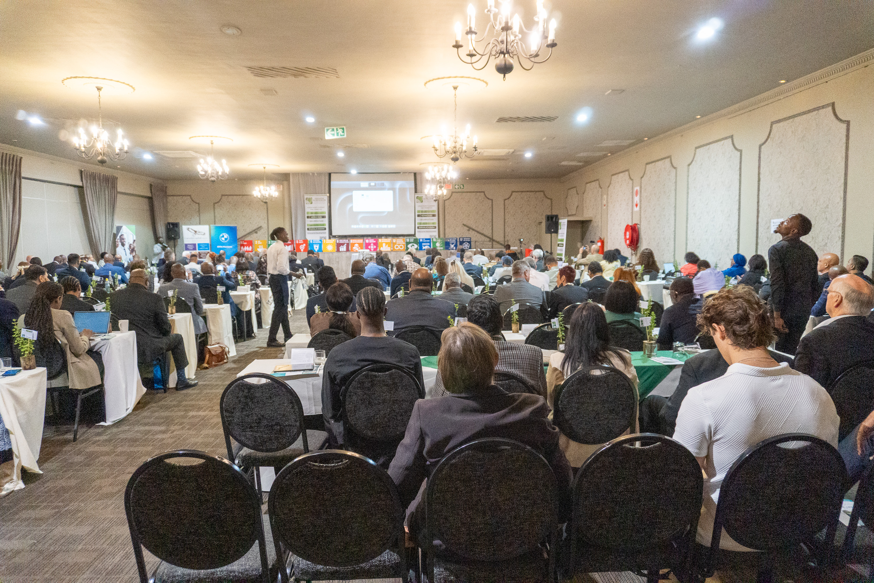 Wide view of the Ambassadors' and Executives Networking Luncheon 2026 at CedarWoods of Sandton, with audience, podium speaker and Innovative Entrepreneurs branding